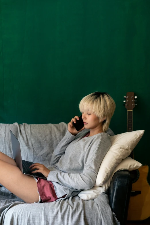 woman talking on her phone while laying on the couch