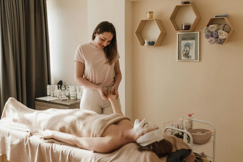 woman receiving massage with foot spa treatment at home