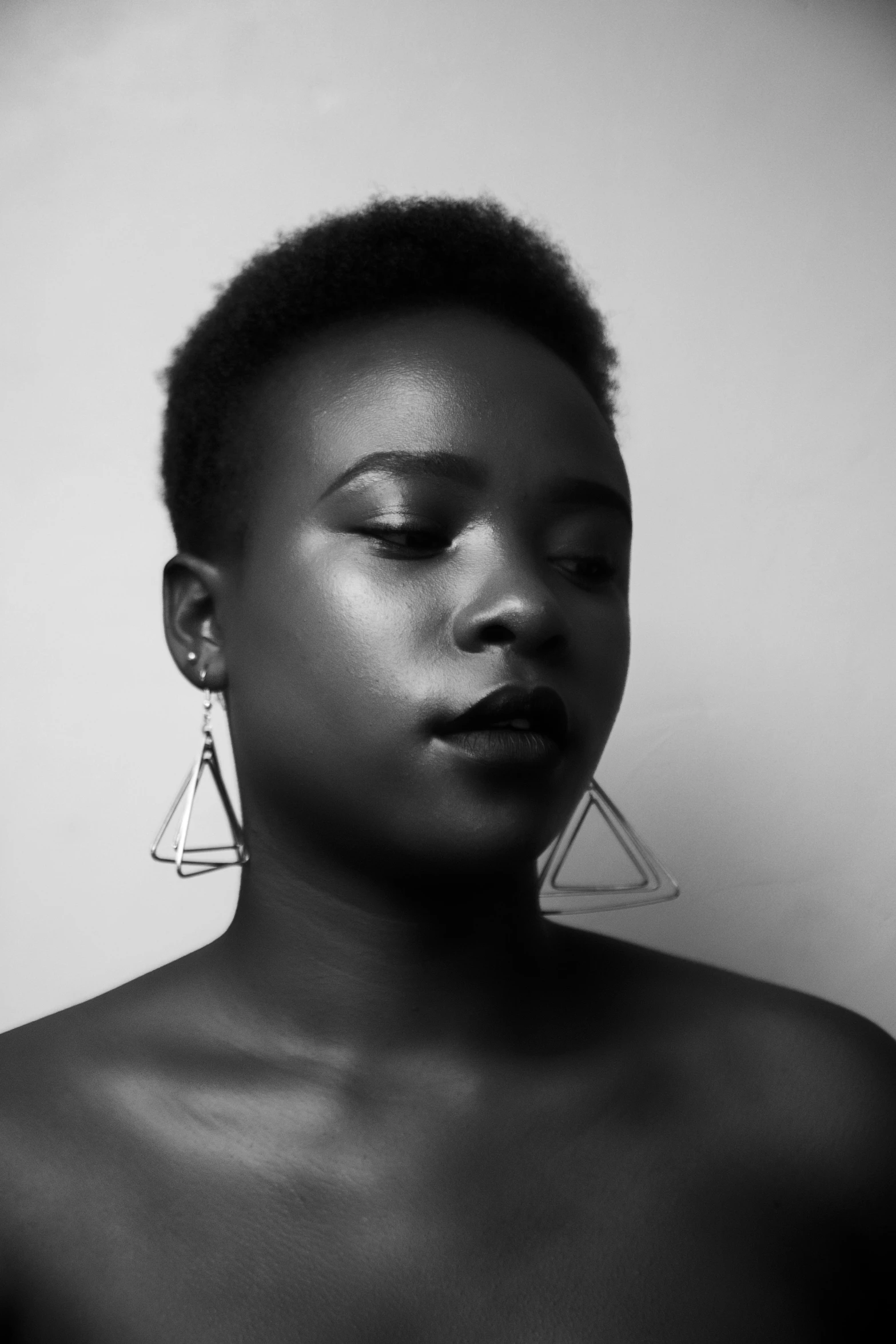 black and white pograph of young african woman wearing large earrings