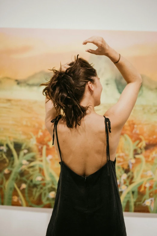 a woman stretching in front of a picture of an image