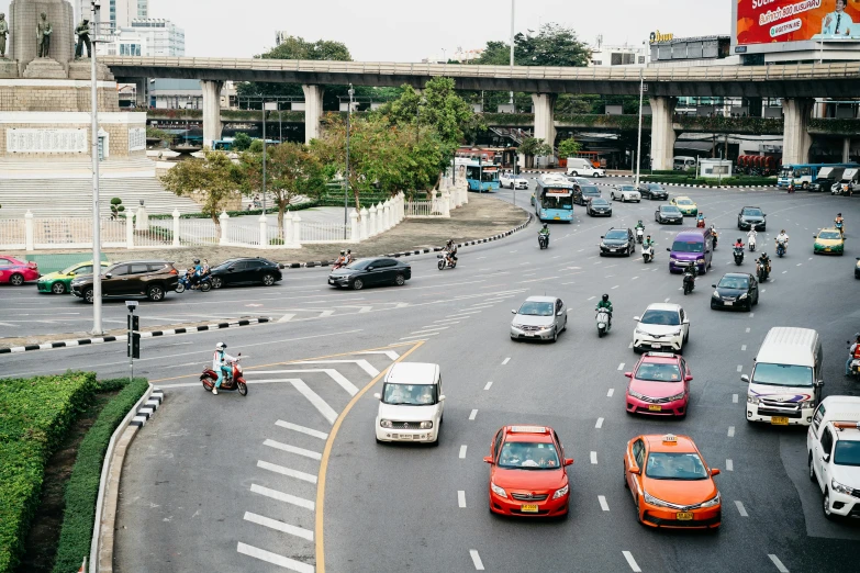 an overview of a busy city street with many cars and motorcycles