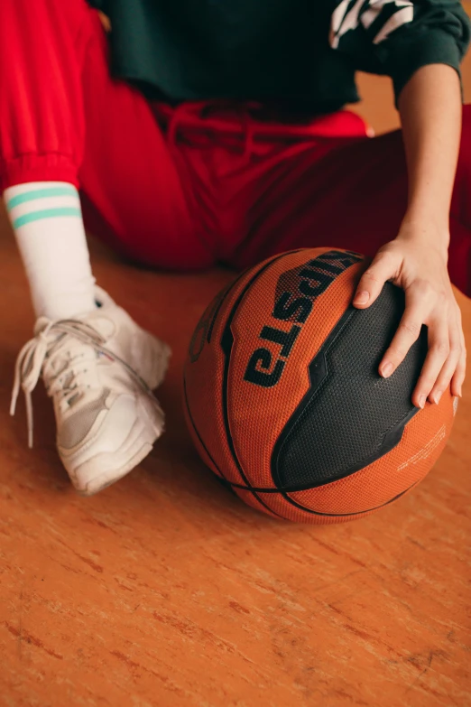 a person is sitting on the floor with a ball