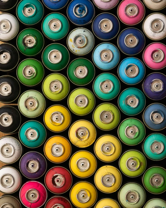 multicolored skateboard wheels are stacked neatly together