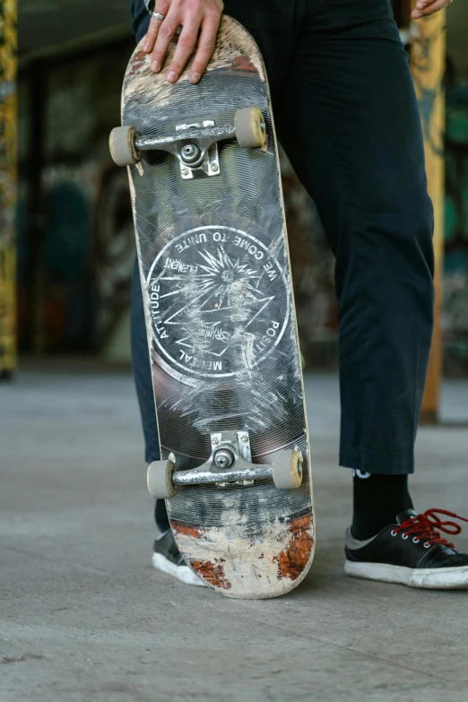 the skateboard is being hed on his legs