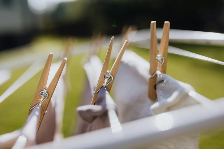 clothes pins are hanging on a clothes line in the grass