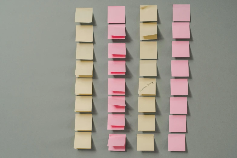 pieces of sticky note paper pinned to a table
