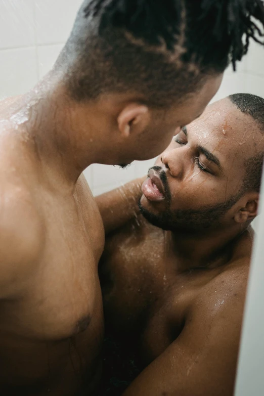 two men in the shower getting a wet face