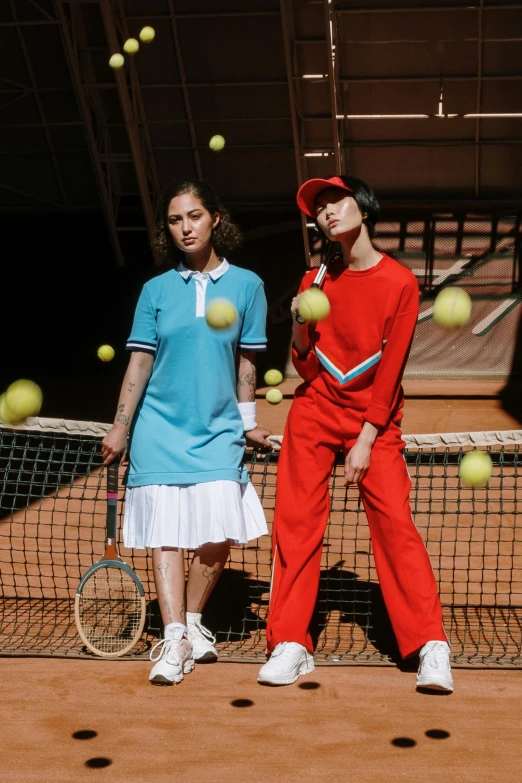 a couple of people are standing on the tennis court