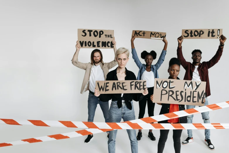 a group of people holding up signs in the middle of a barricade