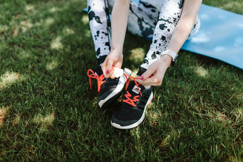 someone is tying up their shoes on the grass