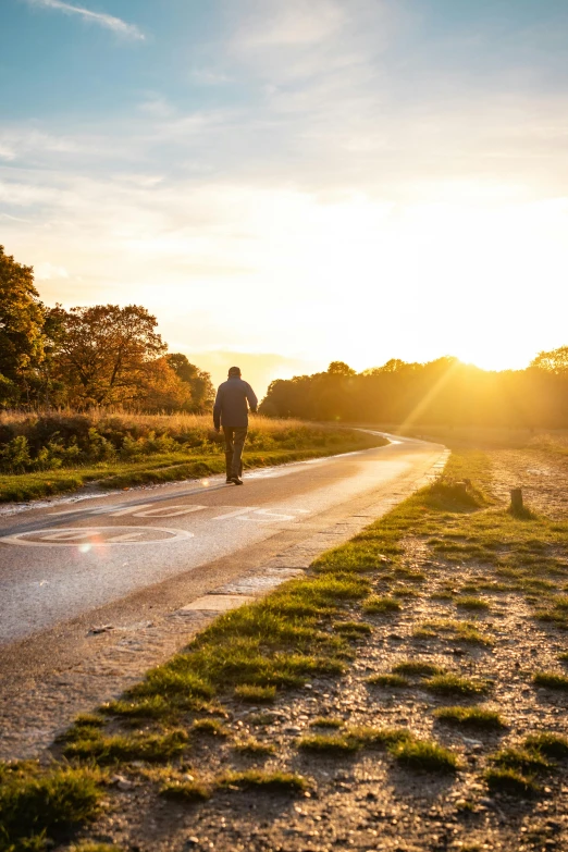 the lone man is walking down the road