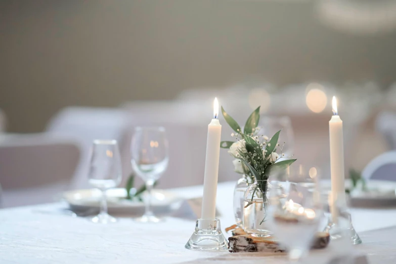 a table with candles and vases with flowers on top