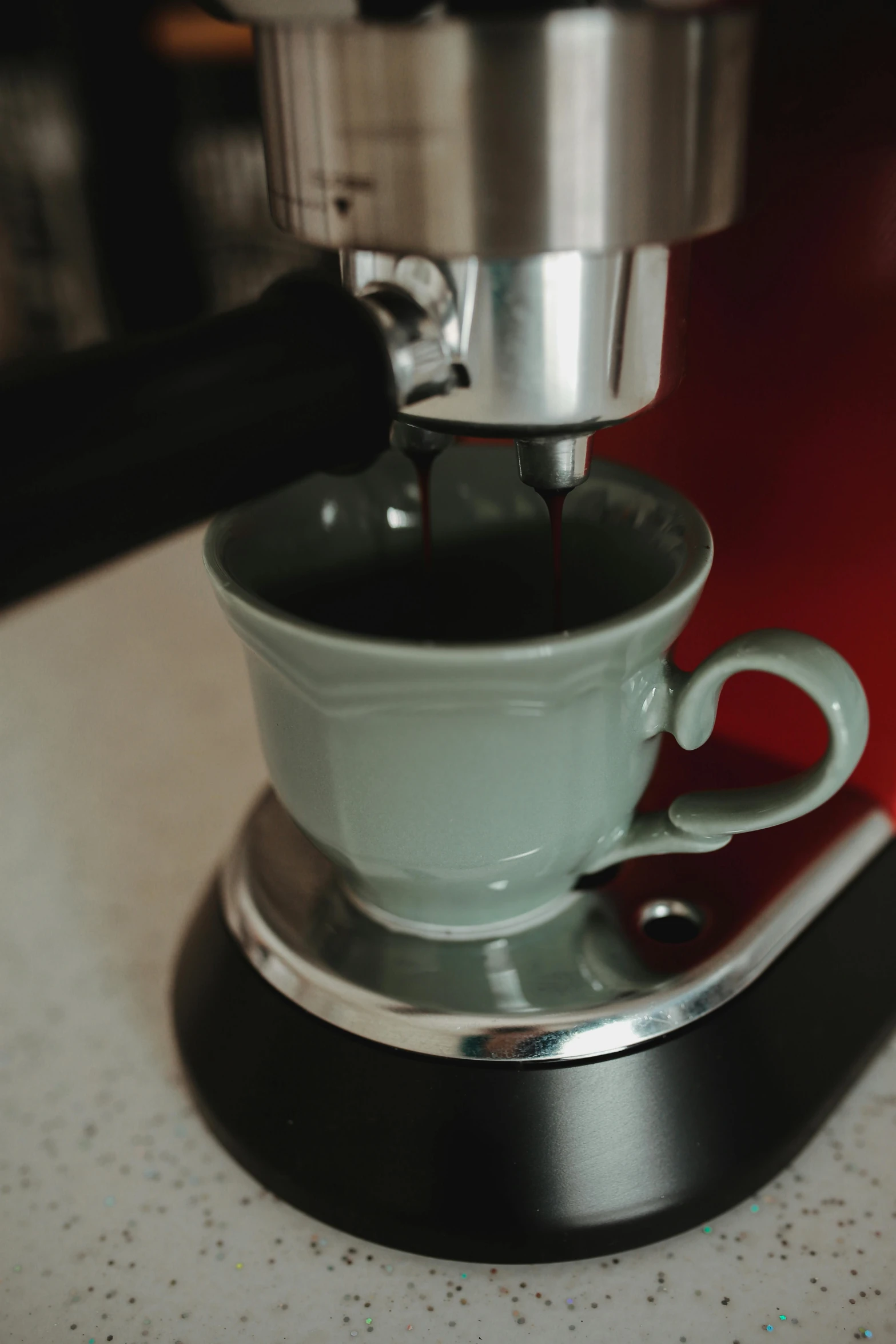 the coffee is being made on a small machine