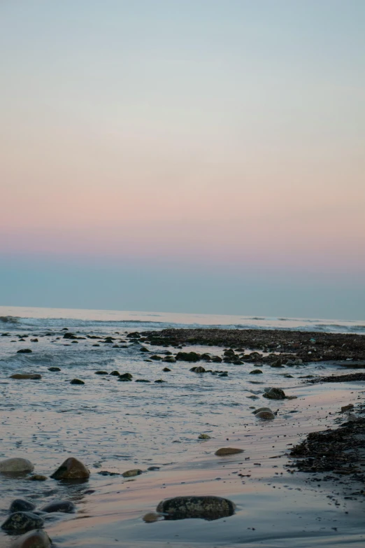 two people standing on the shore of an ocean