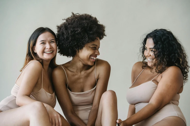 three women in matching underwear pose for the camera