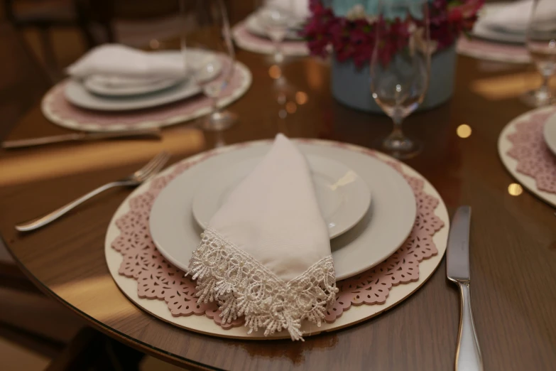 a dinner table set for one or two with a fancy cloth covered napkin