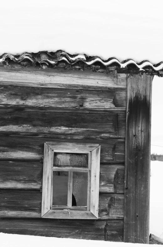 black and white image of a log cabin window