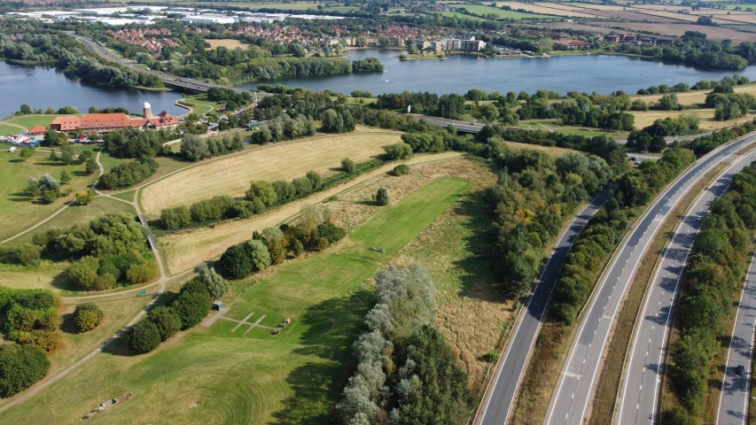 an aerial view of a road through an agricultural area