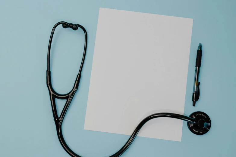 a stethoscope and pen is on a piece of paper