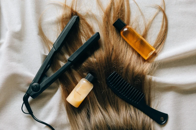 hair products lying next to a comb on top of hair