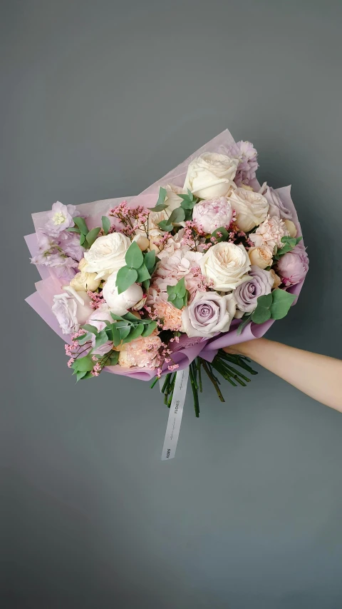 a bouquet of flowers is being held by a person