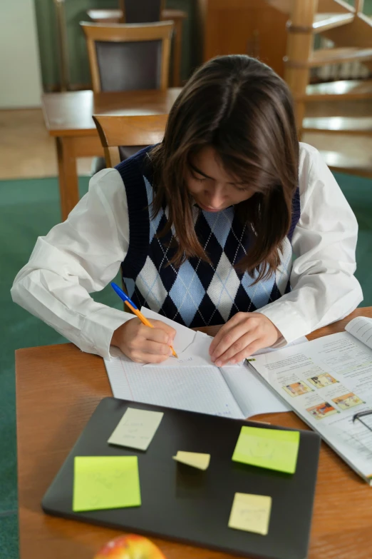 a girl at a desk doing a test in some papers