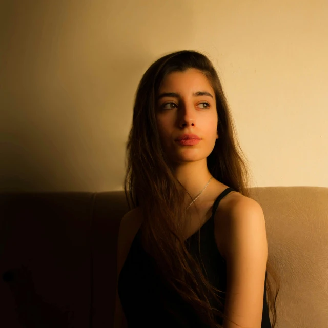 a woman with long hair is posing for the camera