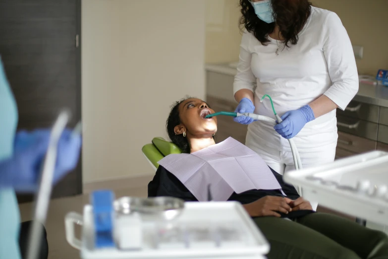 a woman getting ready to use a dental assistant