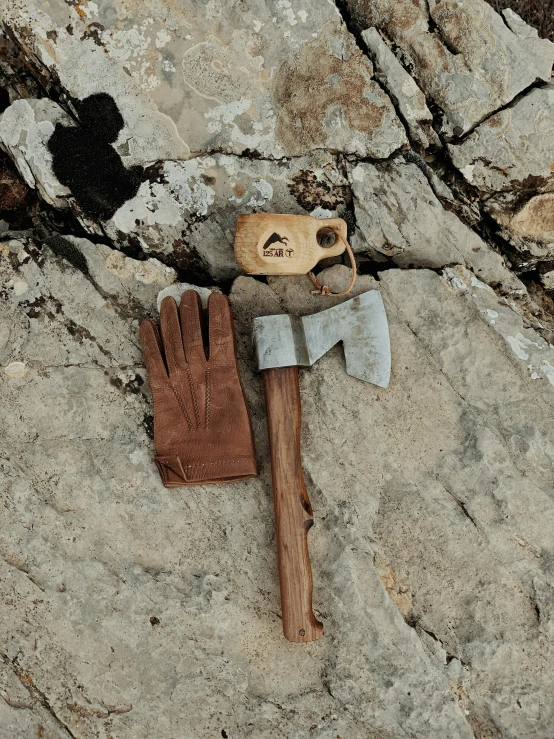 a shovel and gloves lying on some stone