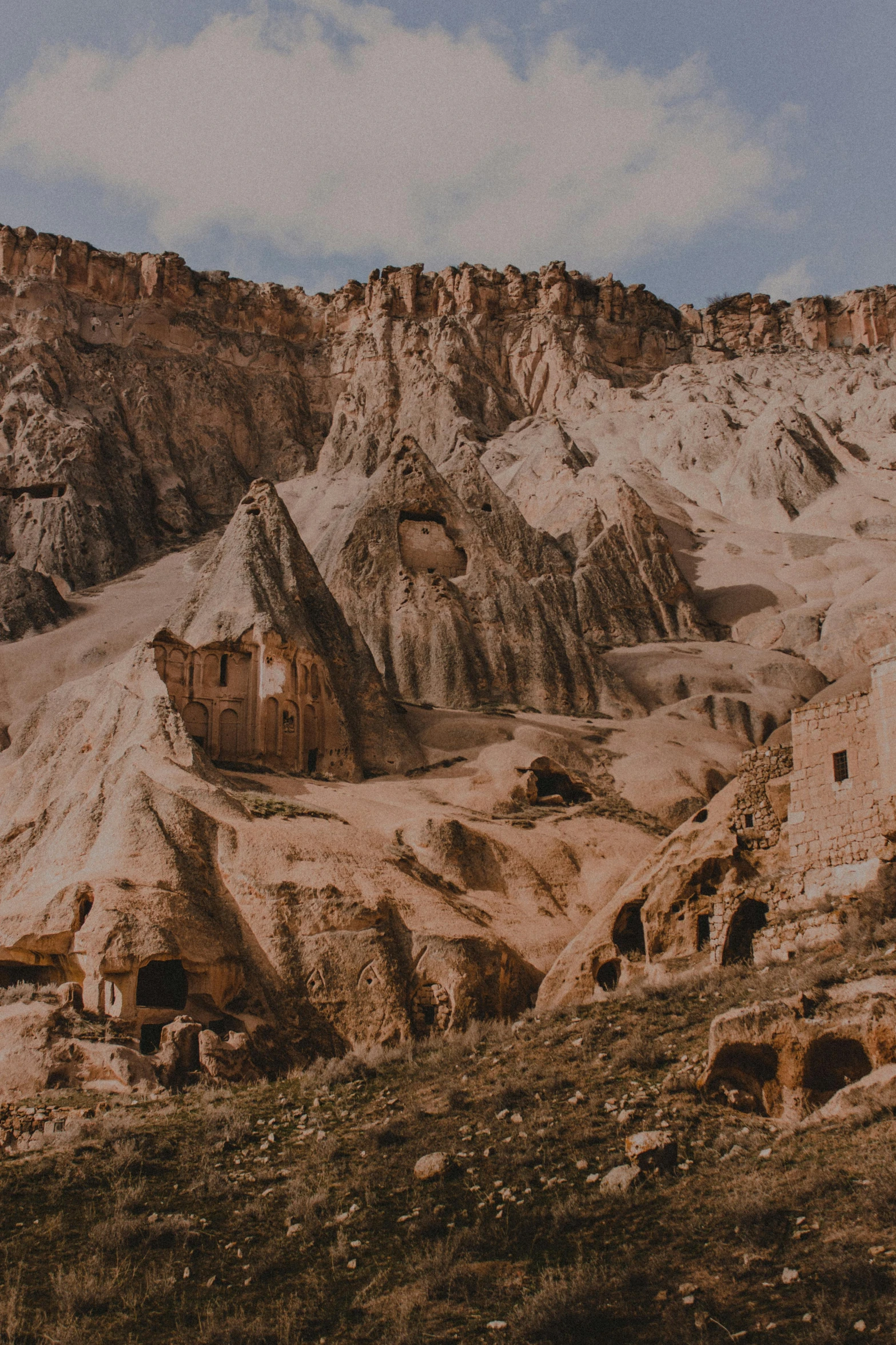 a rocky mountain with some buildings in it