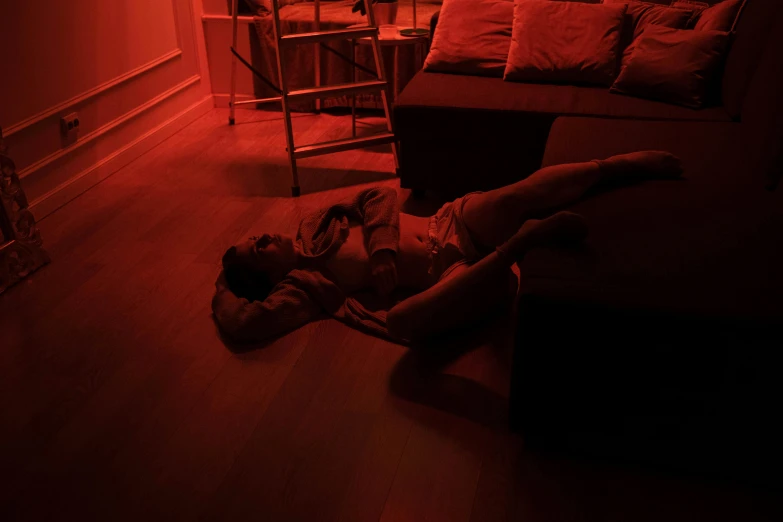 a girl in a red light room laying down