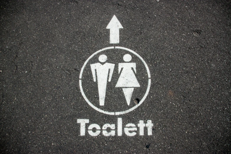 an advertit for toilet on the road with arrows