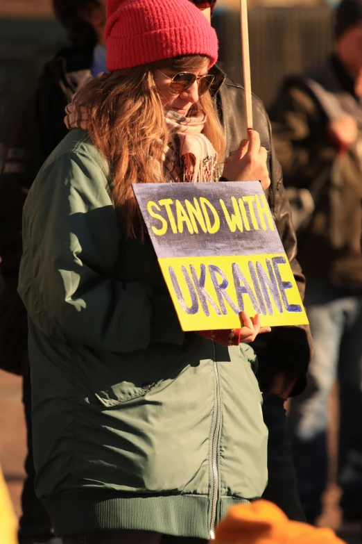 people protesting outside with signs that say sand without surf