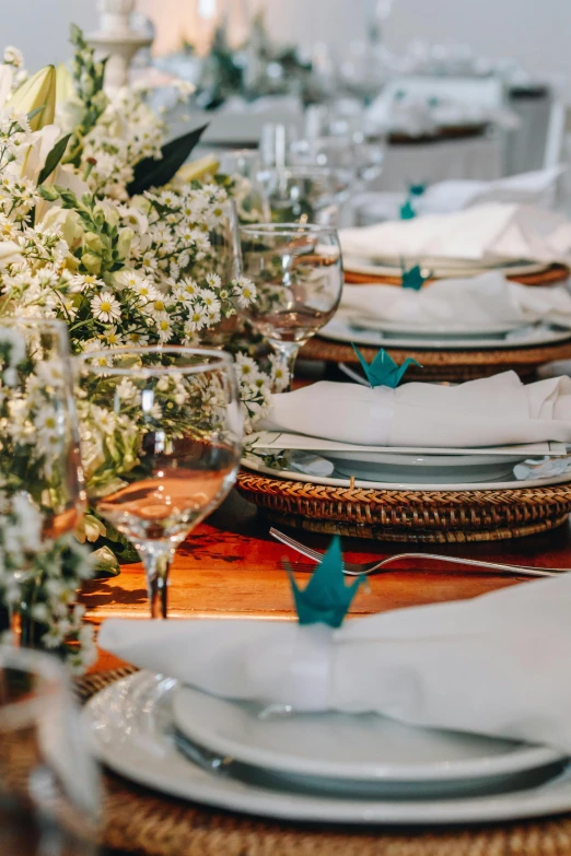 a group of table setting with plates, glasses and napkins