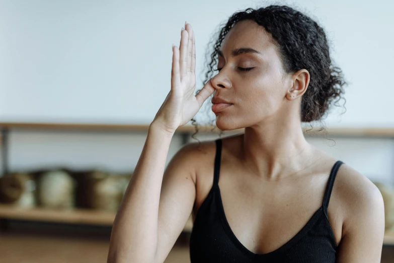 woman wearing a  sitting down in a yoga pose