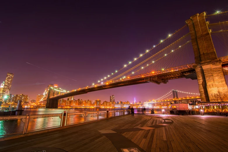 a night view of the city skyline and bridges over the water