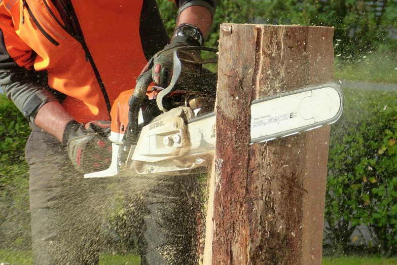 a man using a chainsaw to cut up a tree