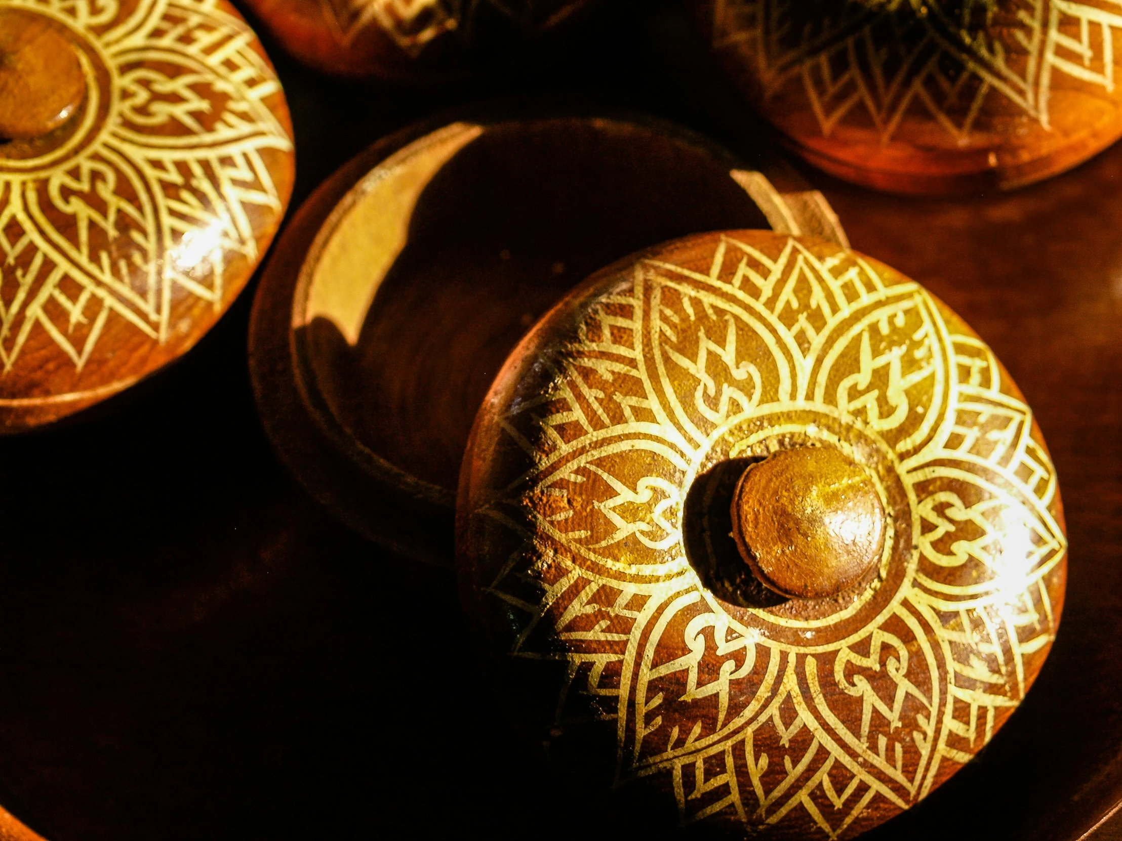 several brown and gold colored handcrafted items sitting on a table