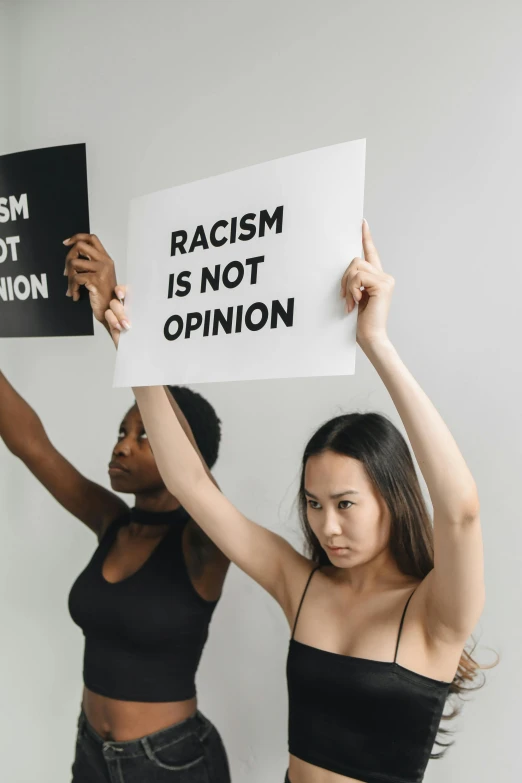 two women with signs and one is holding up the sign