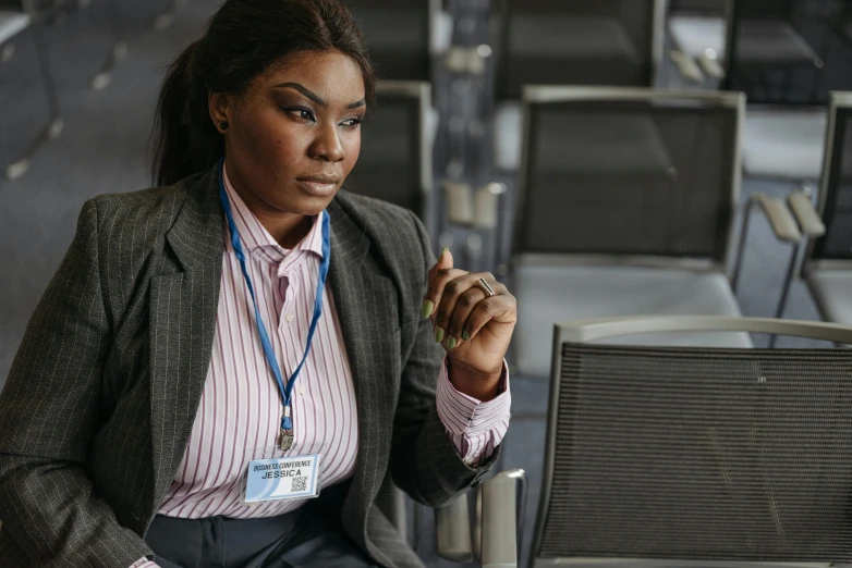 the woman is sitting down at a desk working on her laptop