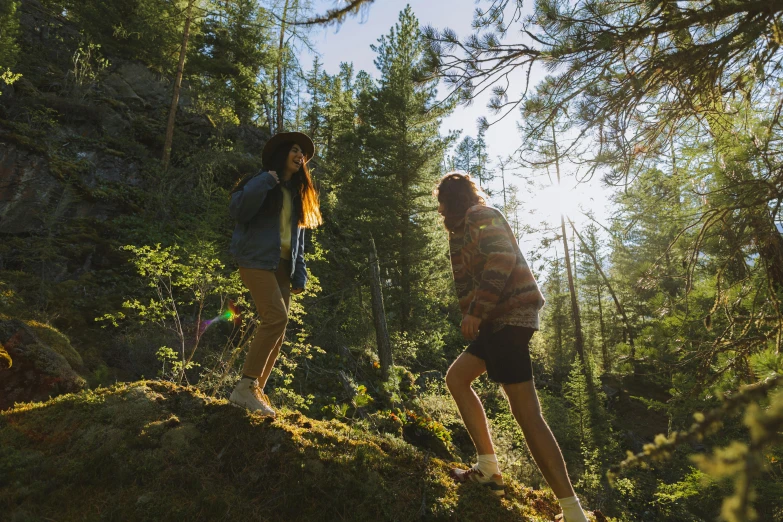 a couple of young women walking through a lush forest