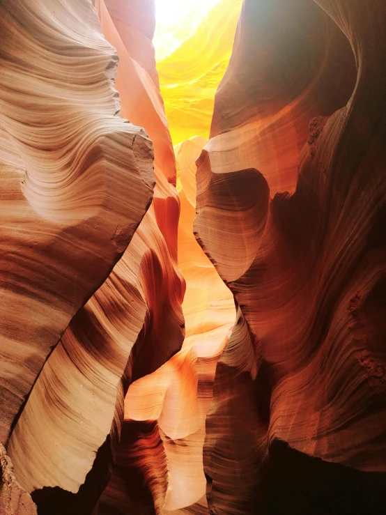 light shines through the gap in a narrow slot of sand