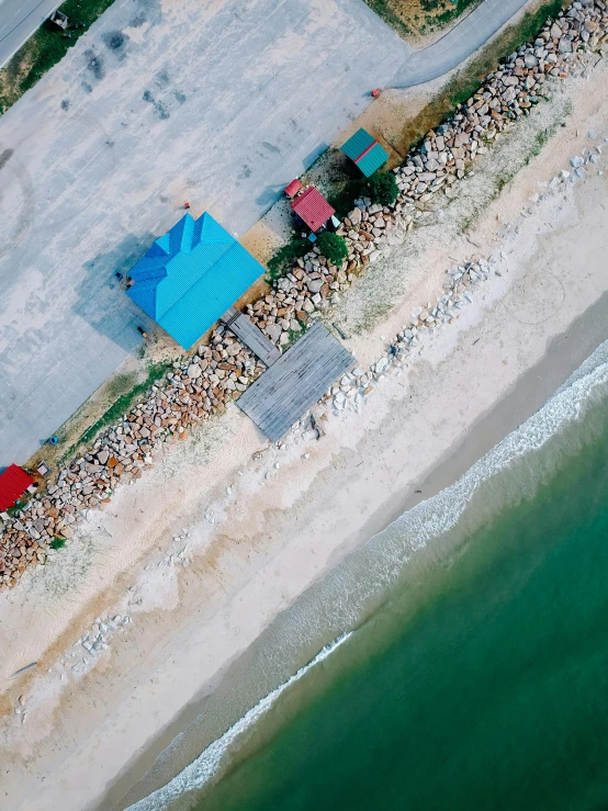 an aerial view of a sandy beach with some people