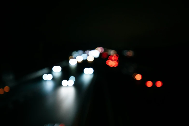 cars traveling in dark on the highway at night