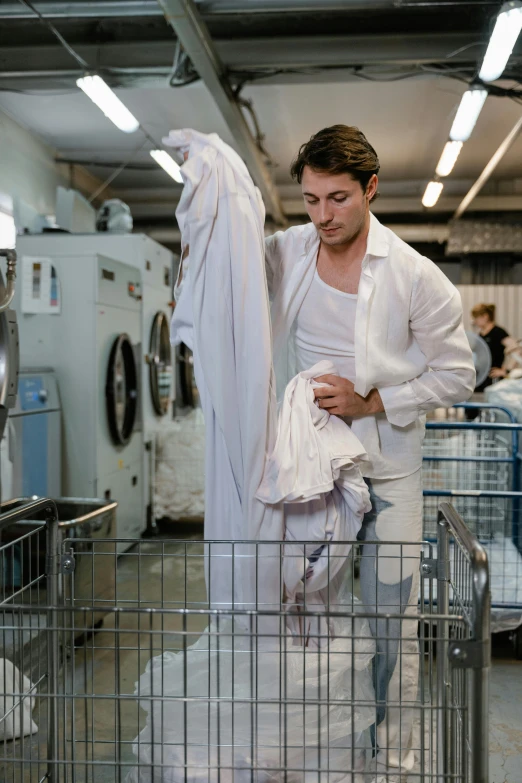 a man in a laundry factory is unpacking clothes