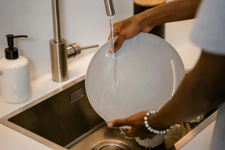 a person preparing a dish in the sink