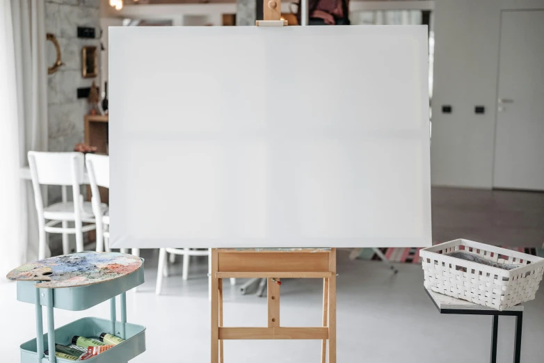 a large painting on a easel stands in a living room