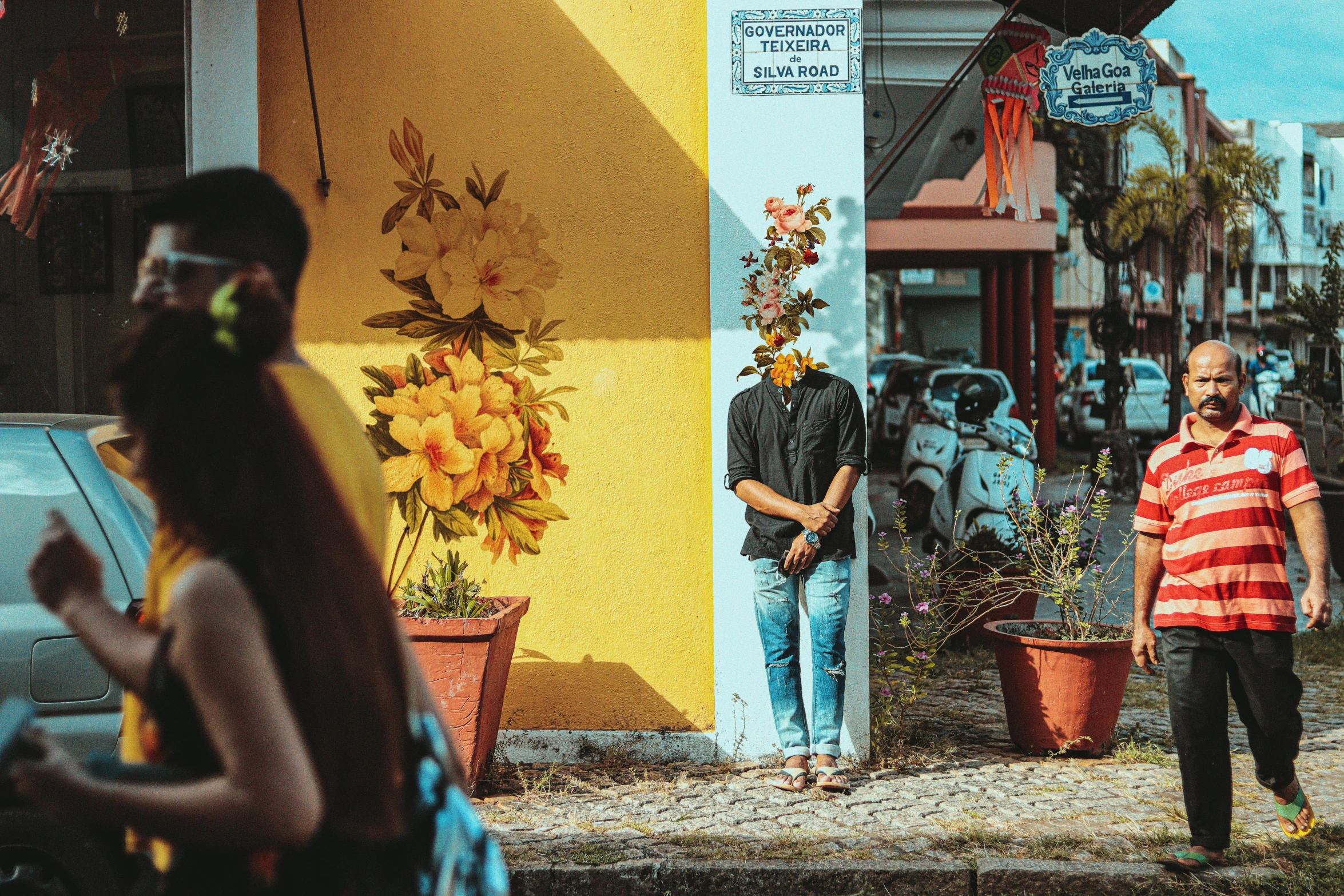 two people are standing outside with their cell phones