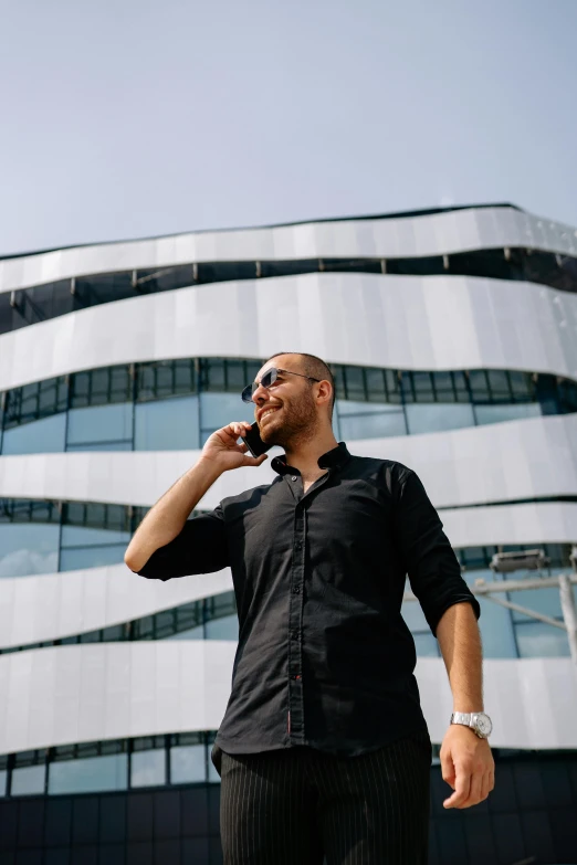 a man is talking on his cell phone while standing outside