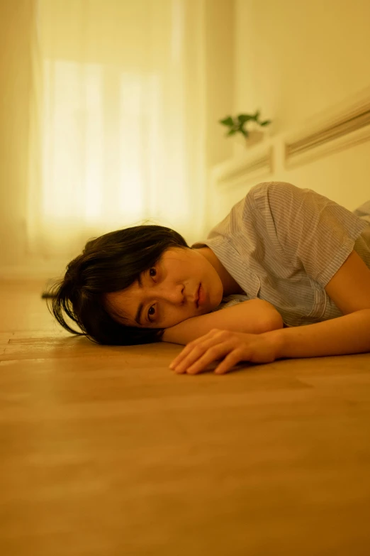 a young woman poses for a pograph on the floor